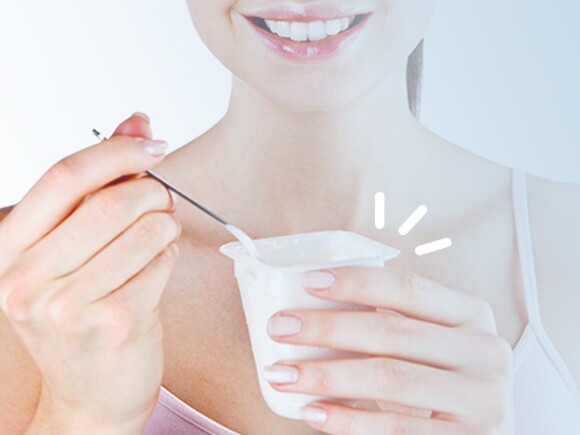 Mãe a comer iogurte com vitaminas e minerais para gravidez saudável