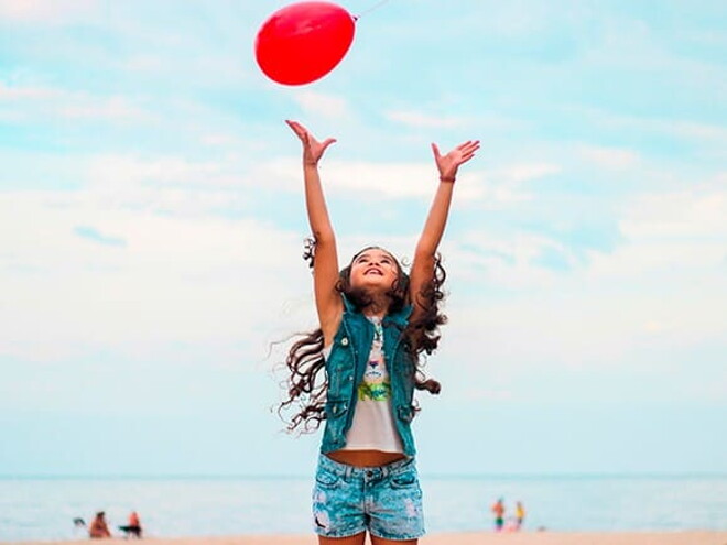 criança feliz com bola 